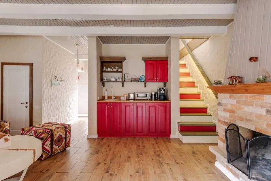 Warm and inviting living room with a modern red cabinetry and fireplace.